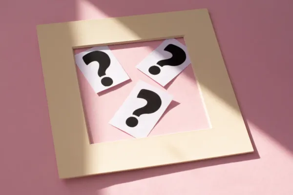 Question marks on cards representing key wedding venue questions to ask during a tour