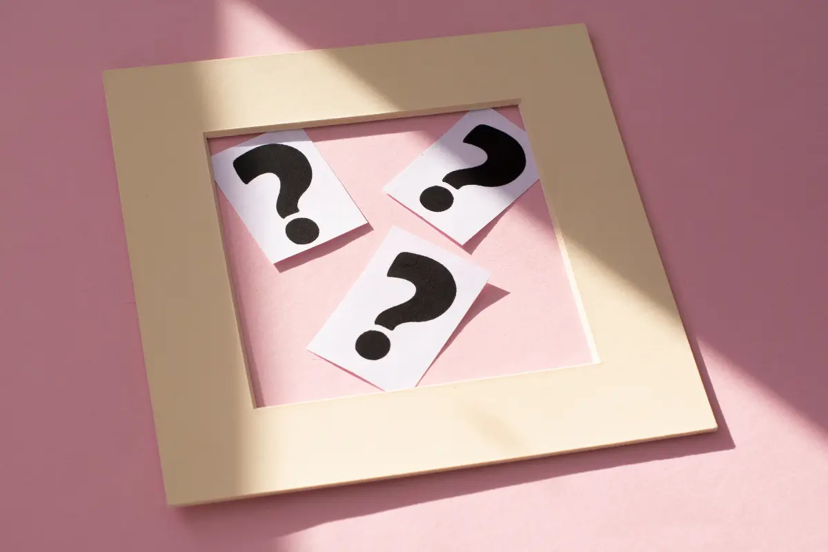 Questions To Ask A Wedding Venue Before You Book Question marks on cards representing key wedding venue questions to ask during a tour